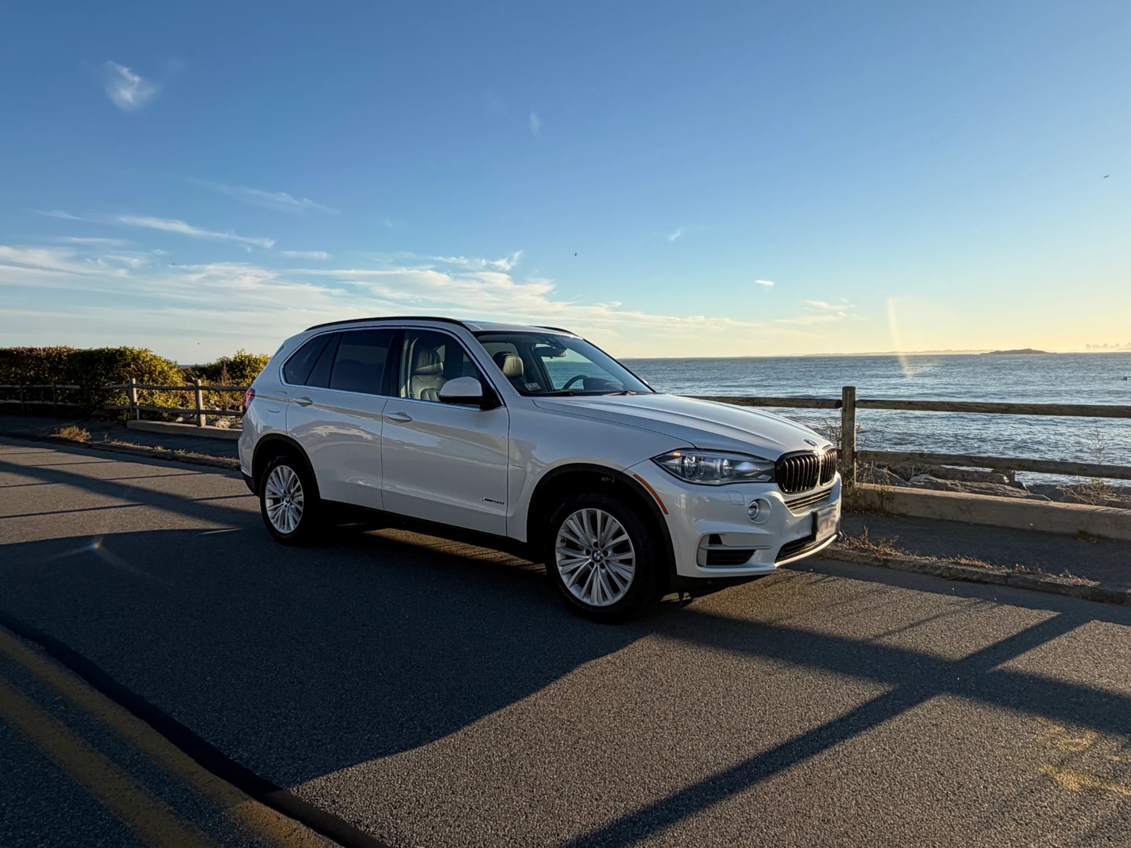 Front three-quarter view, passenger side, with the ocean behind